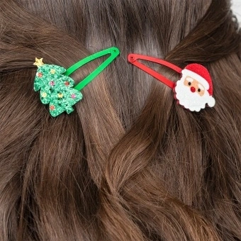 Christmas hair clips featuring Santa faces and glitter Christmas trees