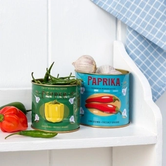 Decorative storage tins labelled "Pepper" and "Paprika" with illustrated peppers