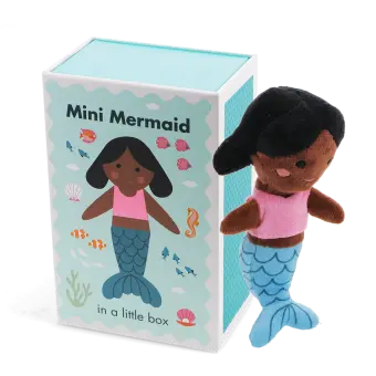 Mini mermaid soft toy placed beside a small illustrated box with mermaid design