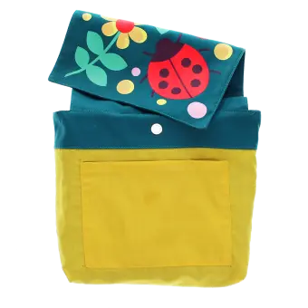 Inside of children’s backpack showing yellow lining, inner pocket, snap closure, and patterned flap