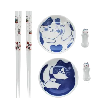 Two cat-themed dipping bowls, two pairs of chopsticks, and two cat-shaped rests.