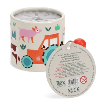 Farmyard‑themed winding music box with illustrated tractor and animals, featuring a red turning handle with tag.