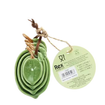 Stackable ceramic measuring spoons shaped like green leaves with brown stem handles with tag