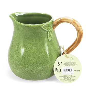 Green ceramic jug with textured surface and a curved brown handle with tag