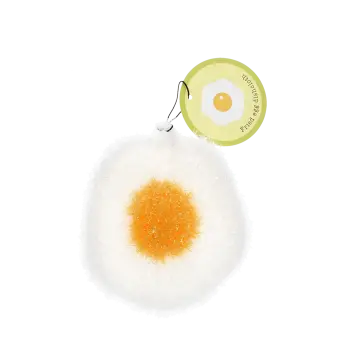 Fried egg–shaped dishcloth with a white textured surface, yellow centre, and hanging loop with tag.