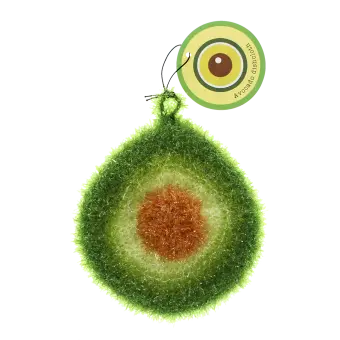 Avocado-shaped dishcloth with textured green layers, brown pit detail, and hanging loop with tag.