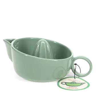 Green stoneware lemon squeezer with handle, spout and an attached product tag.