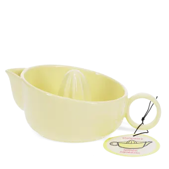 Yellow stoneware lemon squeezer with handle, spout and an attached product tag.