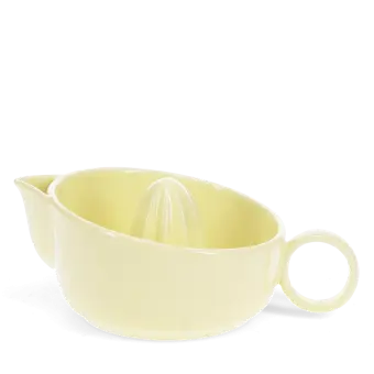 Yellow stoneware lemon squeezer with handle and pouring spout.