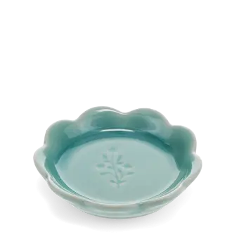 Ceramic trinket dish with a scalloped edge and a floral design in the centre.