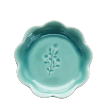 Ceramic trinket dish with a scalloped edge and a floral design in the centre.