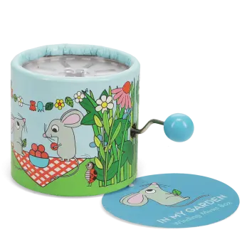 Garden‑themed winding music box with illustrated mice, flowers, and plants, featuring a blue turning handle with tag.