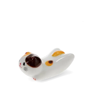 Ceramic cat‑shaped chopstick rest with brown and yellow patches.