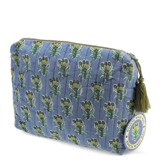 Blue quilted wash bag in blue with a green and blue floral print and a tag.