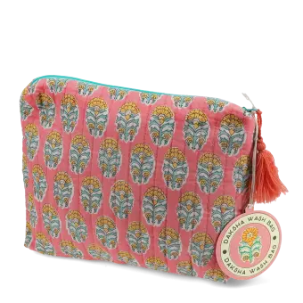 Pink quilted wash bag with orange and green flowers design and a tag.