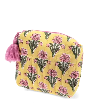Yellow quilted cosmetic bag with a pink and green floral print and a pink tassel on the zip.