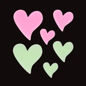 Pink and green glow‑in‑the‑dark heart shapes in assorted sizes on a black background.