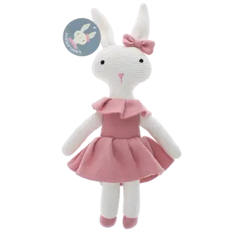 Knitted rabbit toy with long ears, wearing a pink dress with a ruffled collar and a matching bow on one ear