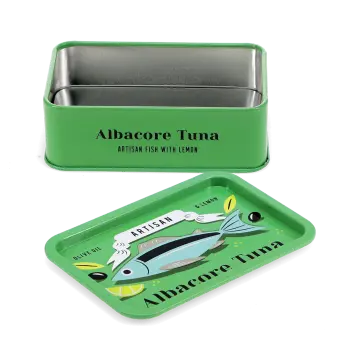 Open mini storage tin with the lid beside it, featuring an illustrated tuna on the lid.