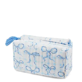 Light blue quilted makeup bag with a bow pattern and tassel.