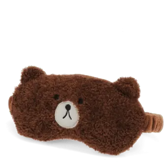 Brown plush teddy bear–shaped travel eye mask with embroidered facial features.