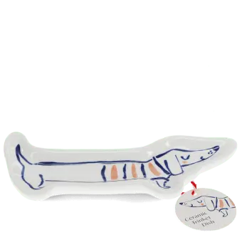 White ceramic trinket dish shaped like a long sausage dog with a tag.