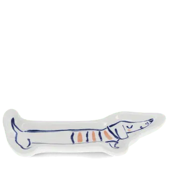 White ceramic trinket dish shaped like a long sausage dog with blue and orange details.