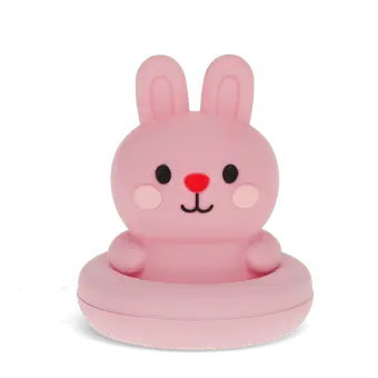 Pink silicone bunny bath toy with upright ears and simple face, in round base