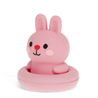 Pink silicone bunny bath toy with upright ears and simple face, in round base