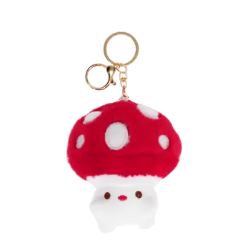 Plush mushroom bag charm with red spotted cap, gold keyring and soft white base