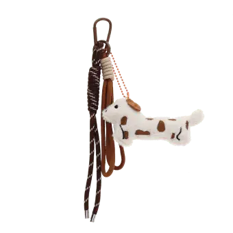 Plush sausage dog bag charm with brown spots, cord strap and clip.