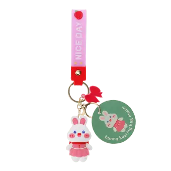 Bunny bag charm with pink outfit, silicone wrist strap and bow detail with tag.