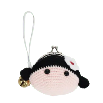 Crochet girl-shaped coin purse with a metal clasp and hanging bell charm.