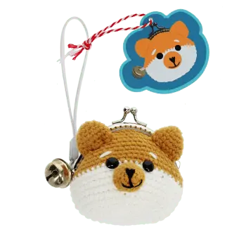 Crochet fox-shaped coin purse with a metal clasp and hanging bell charm with tag.