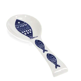 White ceramic spoon rest with blue fish design.