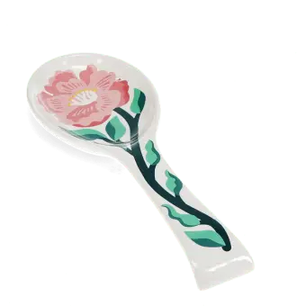 White ceramic spoon rest with blue fish design.