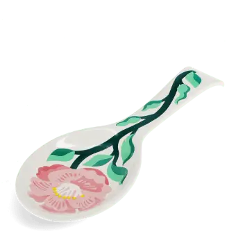White ceramic spoon rest with blue fish design.