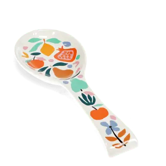 White ceramic spoon rest with a colourful fruit and leaf design.