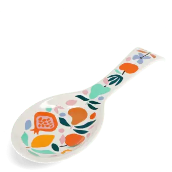 White ceramic spoon rest with a colourful fruit and leaf design.