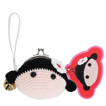 Crochet girl-shaped coin purse with a metal clasp and hanging bell charm with tag.