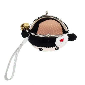 Crochet girl-shaped coin purse with a metal clasp and hanging bell charm with tag.