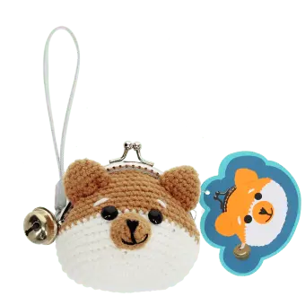 Crochet fox-shaped coin purse with a metal clasp and hanging bell charm with tag.