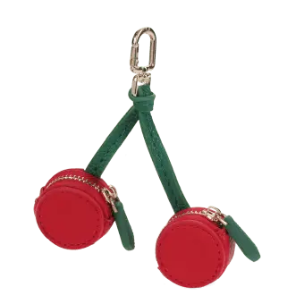 Cherry-shaped coin purse with zip compartments, green strap and gold-tone keychain.