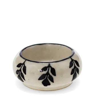 Round ceramic tealight holder with black leaf pattern 