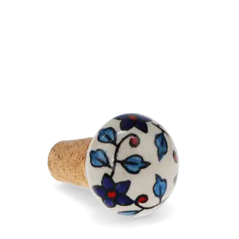 Ceramic and cork bottle stopper with floral and leaf pattern.