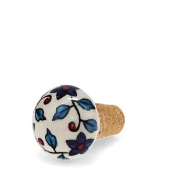 Ceramic and cork bottle stopper with floral and leaf pattern.