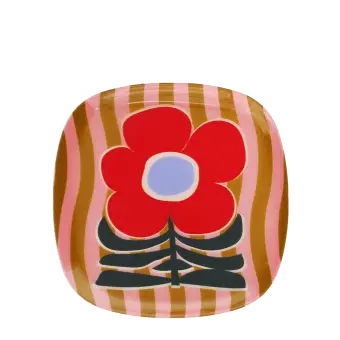 Square metal trinket tray with bold red flower design on a pink striped background.