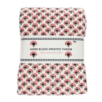Hand block-printed throw with red floral pattern, folded in packaging.